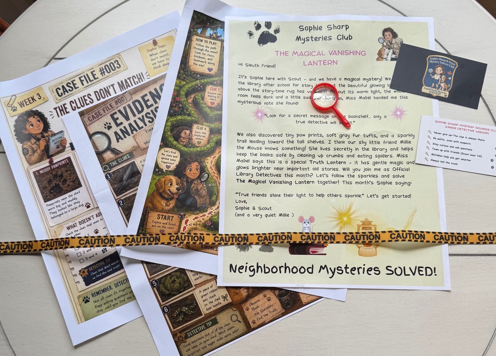 A Sophie Sharp Mysteries case file laid out — booklet, membership card, magnifying glass and detective extras